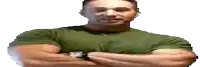 a man in a green shirt with his arms crossed is wearing a watch .