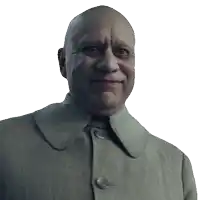 a bald man in a grey coat with buttons on the collar is smiling