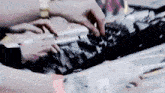 a person is playing a keyboard with their hands