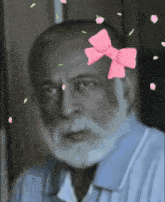 an older man with a pink bow on his head
