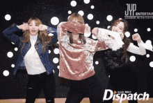 a group of girls are dancing in front of a sign that says dispatch