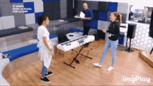 a woman is dancing in front of a keyboard in a room