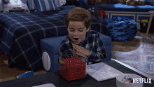a boy sitting at a table with a bowl of red beans and a netflix logo