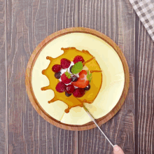 a cheesecake with strawberries and blueberries on top of it