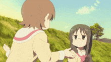a girl with glasses stands on a grassy hill