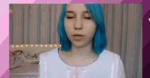 a girl with blue hair is wearing a white shirt and a pink bow .