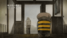 a man in a yellow and black striped shirt stands in a doorway next to another man