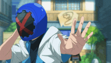 a man wearing a blue helmet with a red cross on it