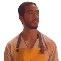 a man wearing a yellow apron and a white shirt has blood on his shirt