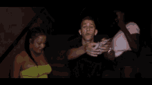 a group of people are standing around a man holding a bunch of money