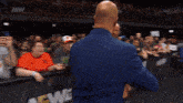 two men are standing in front of a aew banner