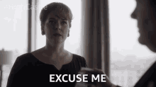 a woman says " excuse me " in front of a man