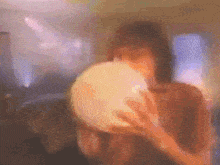 a blurry picture of a person holding a large object
