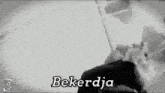 a black and white photo of a person with the word bekerdja written on the bottom .
