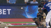 a baseball player wearing a blue jersey with the number 2 on it