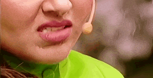 a close up of a woman 's mouth with a microphone on her head .