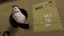 a penguin is holding a piece of paper that says `` get to it ! ''