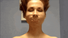a woman with her eyes closed and her mouth open