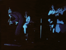 a black and white photo of a band playing instruments