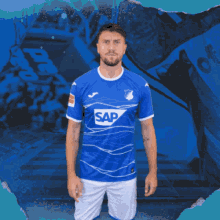 a man wearing a blue shirt with sap on it