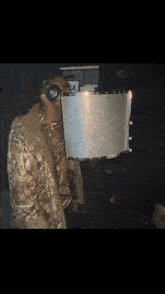 a man wearing a camo jacket is standing in front of a microphone