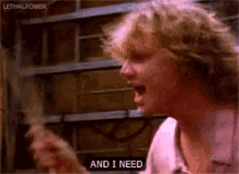 a man is screaming and saying `` and i need '' while holding a guitar .