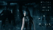 a woman in a black corset stands in front of a city