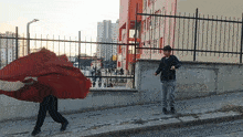 a boy walking down a sidewalk with graffiti on the wall that says ' para ' on it