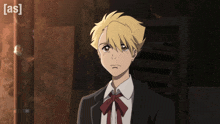 a boy in a suit with a red bow tie is standing in front of a door with the word [ as ] on it