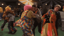 a man in a clown costume is holding another man