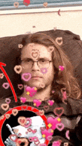 a man wearing glasses and a sweater with hearts around his face