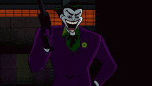 the joker is holding a gun in his right hand