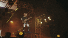 a person playing a guitar with hba on their shorts