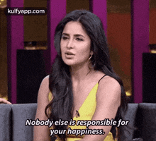 a woman in a yellow dress is sitting on a couch and saying `` nobody else is responsible for your happiness '' .
