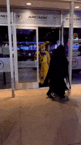 a person in a bunny costume is standing in front of an arcade