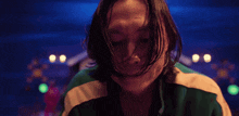 a close up of a person 's face with long hair .