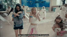 a woman says one million volt thunderbolt it 's pumping in front of a group of women