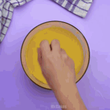 a person is pouring a cup of coffee into a bowl of food