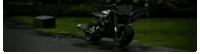 a close up of a person riding a motorcycle on a grassy field .