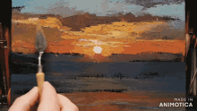 a person is painting a sunset with the words made in animotica on the bottom