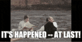 a man and a woman are sitting in a boat on a river with the words `` it 's happened at last '' .