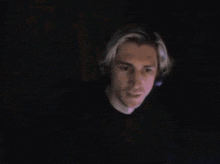 a blurry picture of a man 's face with a headset on .