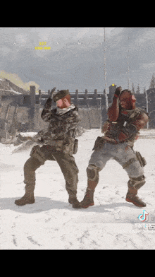 two soldiers are dancing in the snow in a video game