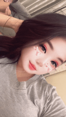 a woman with a bow on her face takes a picture