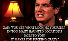 a man in a dark room with a lamp and a quote that says zak you see what locking yourself in too many haunted locations