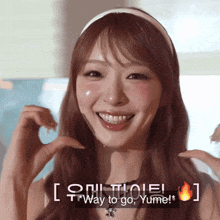 a woman is smiling and making a heart with her hands and the words way to go yume