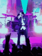 a man is singing into a microphone on a stage