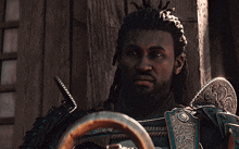 a man with dreadlocks is looking at something in a video game