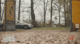 a car is driving through a gate that says kraus