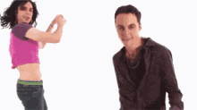 a man and a woman are dancing together and the woman is wearing a crop top